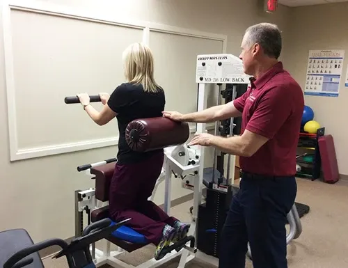Dr. Daniel Garvey guiding a patient through rehab exercises